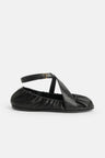 Ballerina in black leather with leather straps