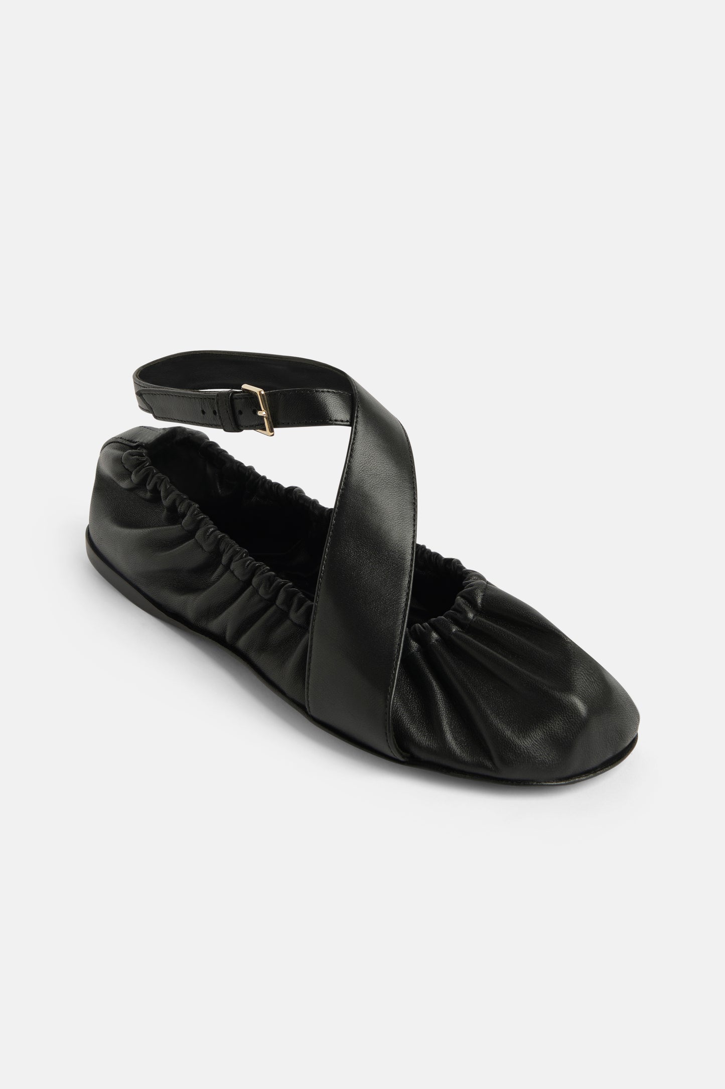 Ballerina in black leather with leather straps
