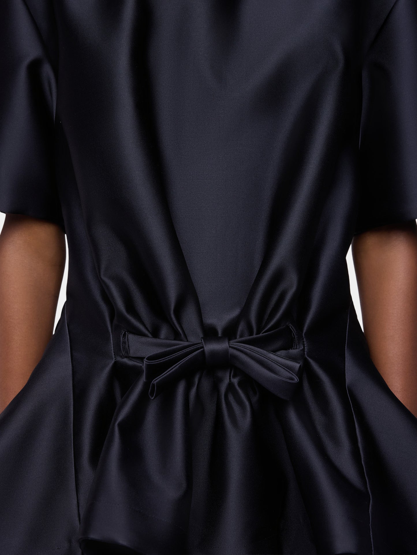 Tailored top in black satin with bow detail
