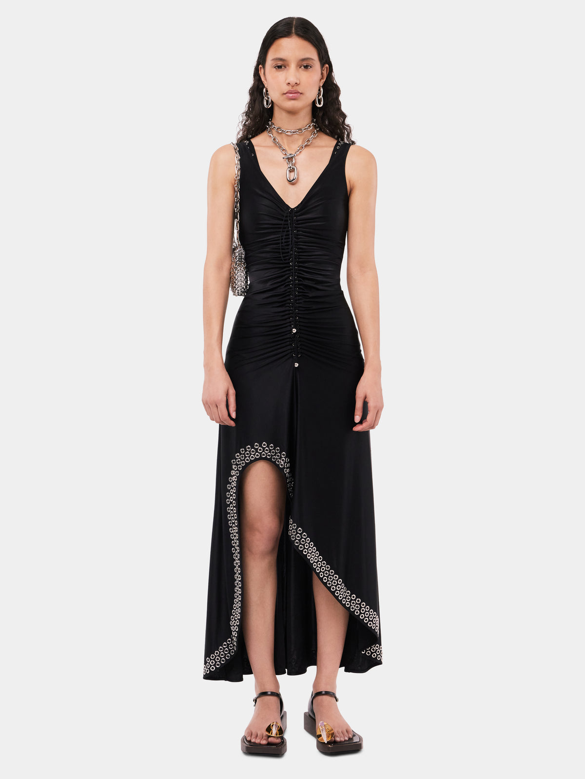 Long black dress with embroidered metallic eyelets