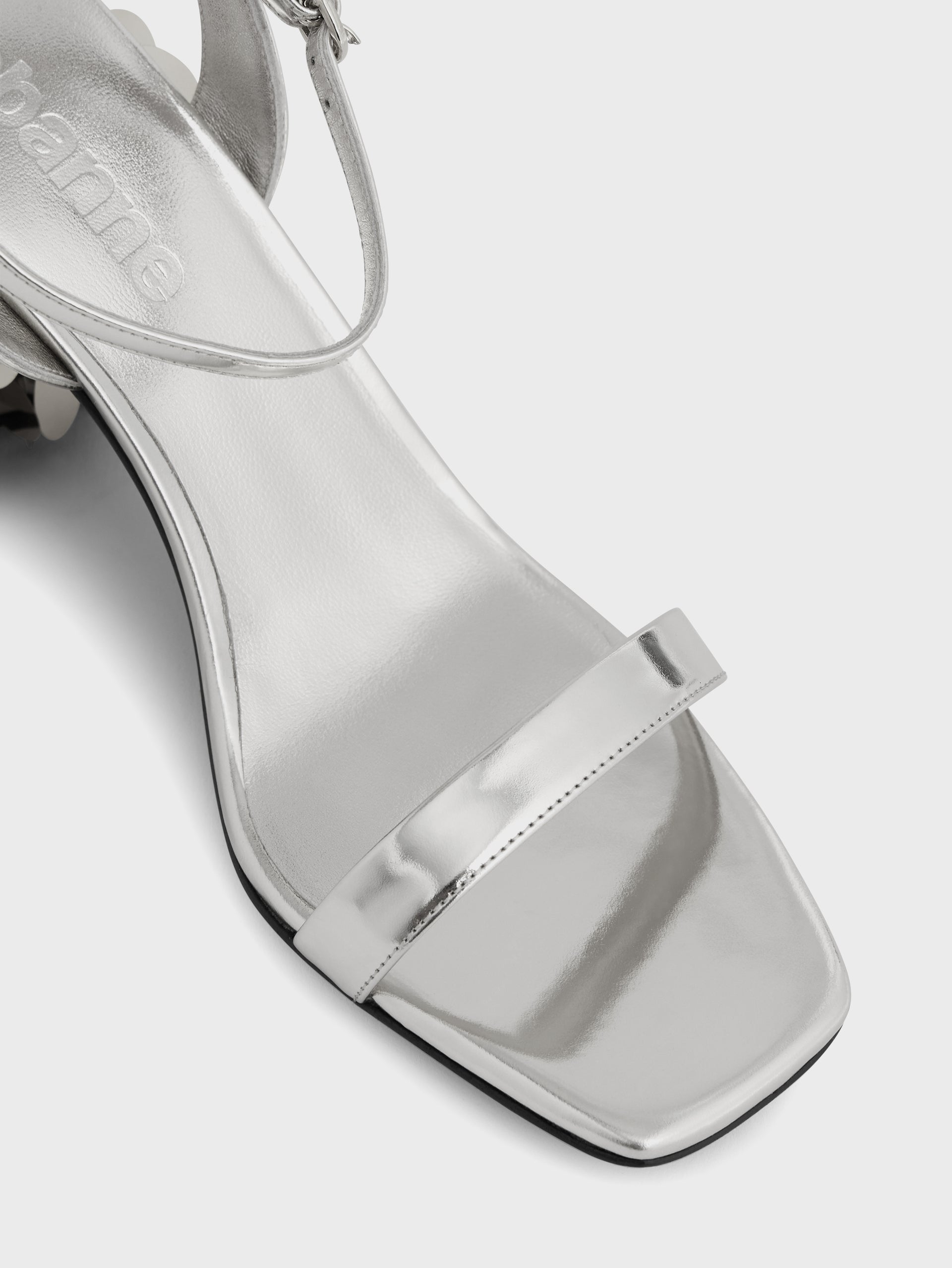 Silver sandals with sparkle discs heels