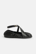 Ballerina in black leather with leather straps