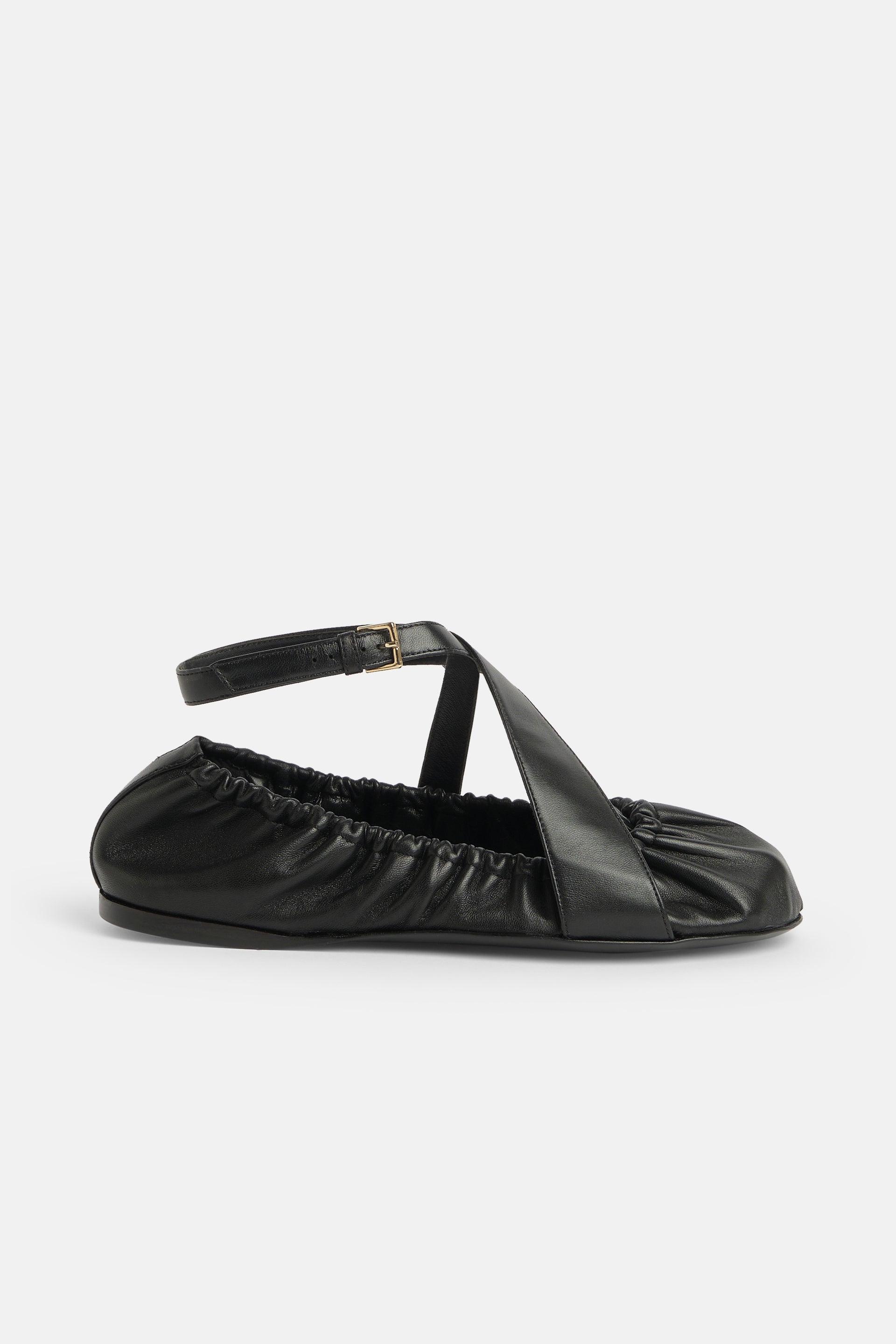 Ballerina in black leather with leather straps