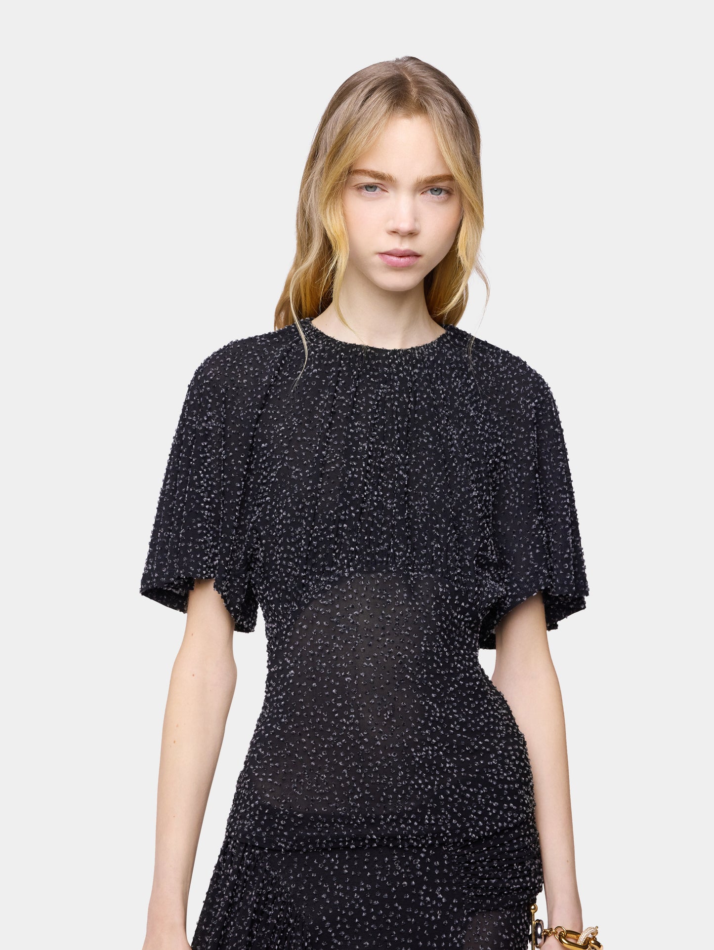 Textured asymmetrical black top with ruched details