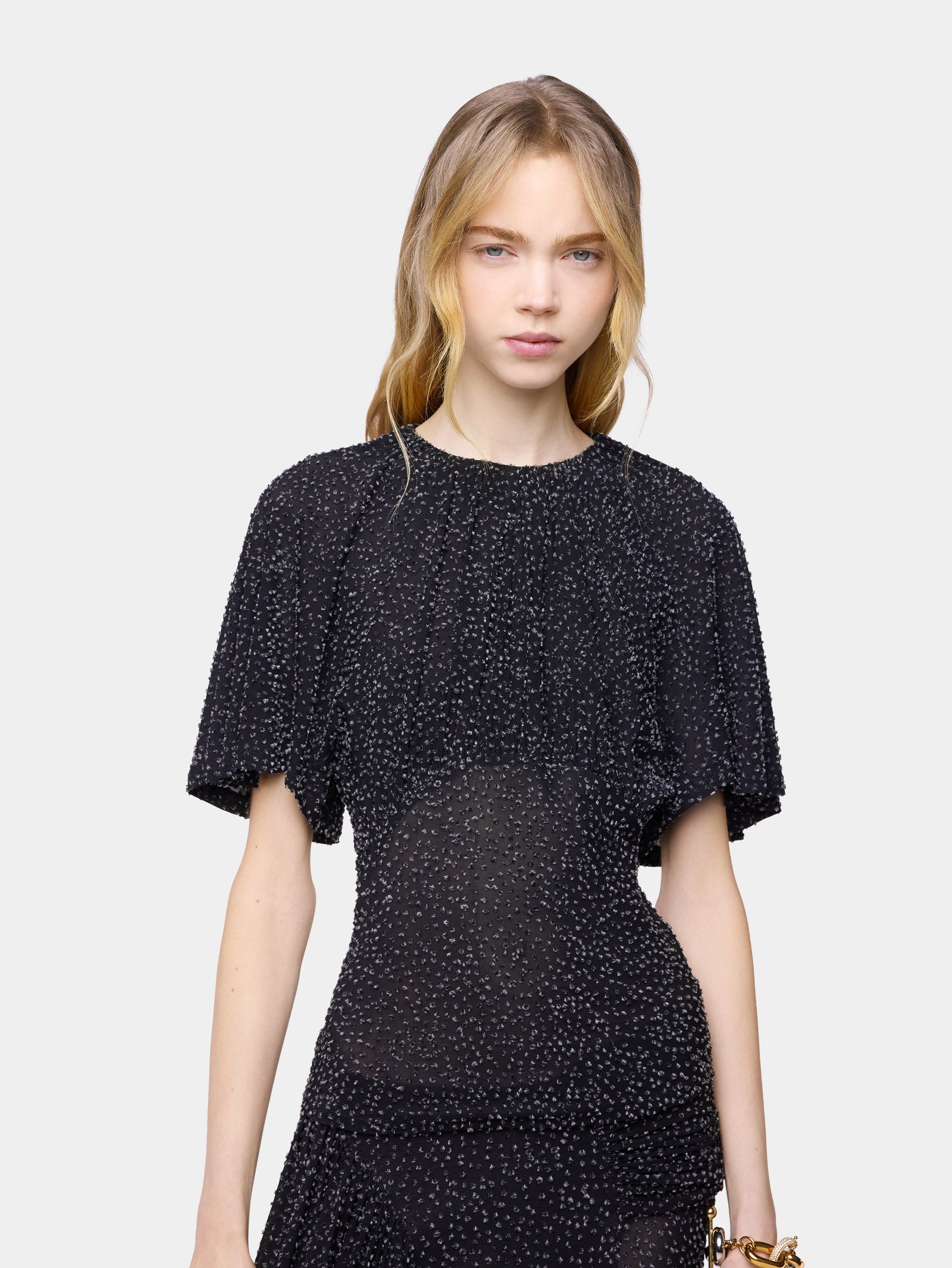 Textured asymmetrical black top with ruched details