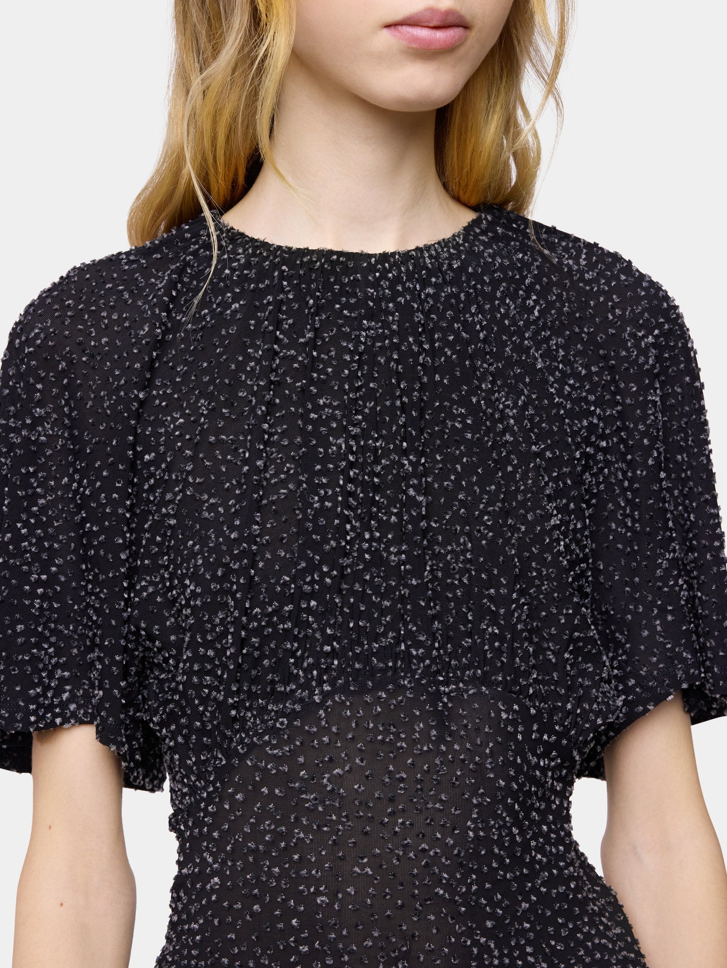 Textured asymmetrical black top with ruched details