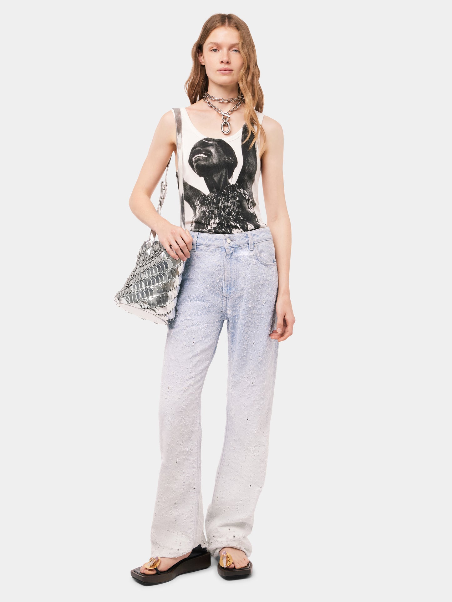 Scratched raw light blue jeans