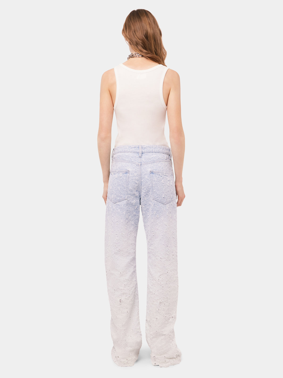 Scratched raw light blue jeans
