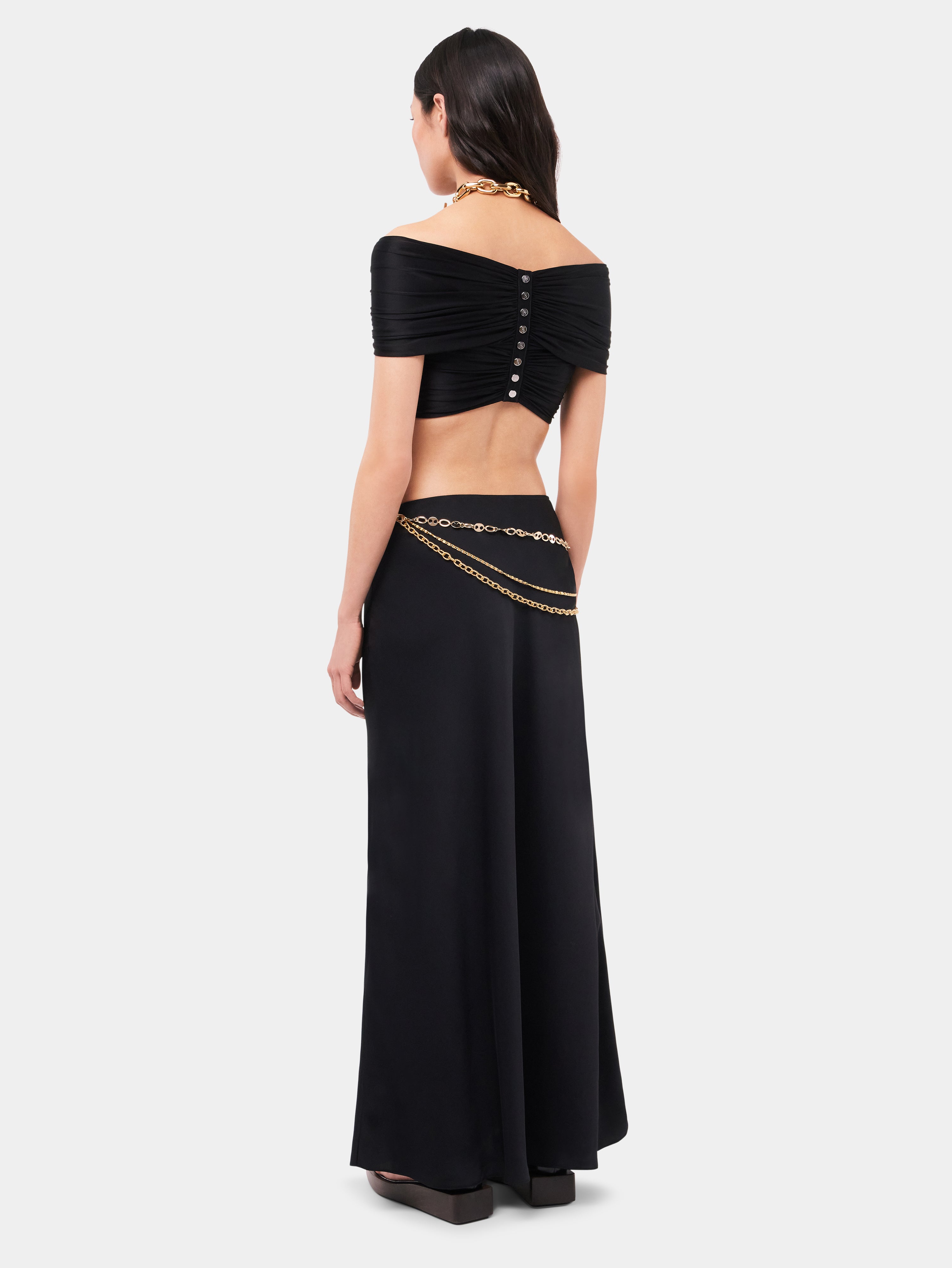 Long black skirt embellished with 