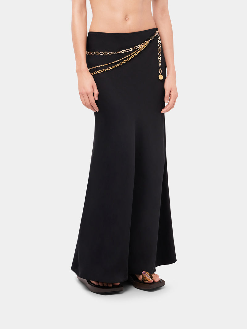 Long black skirt embellished with 