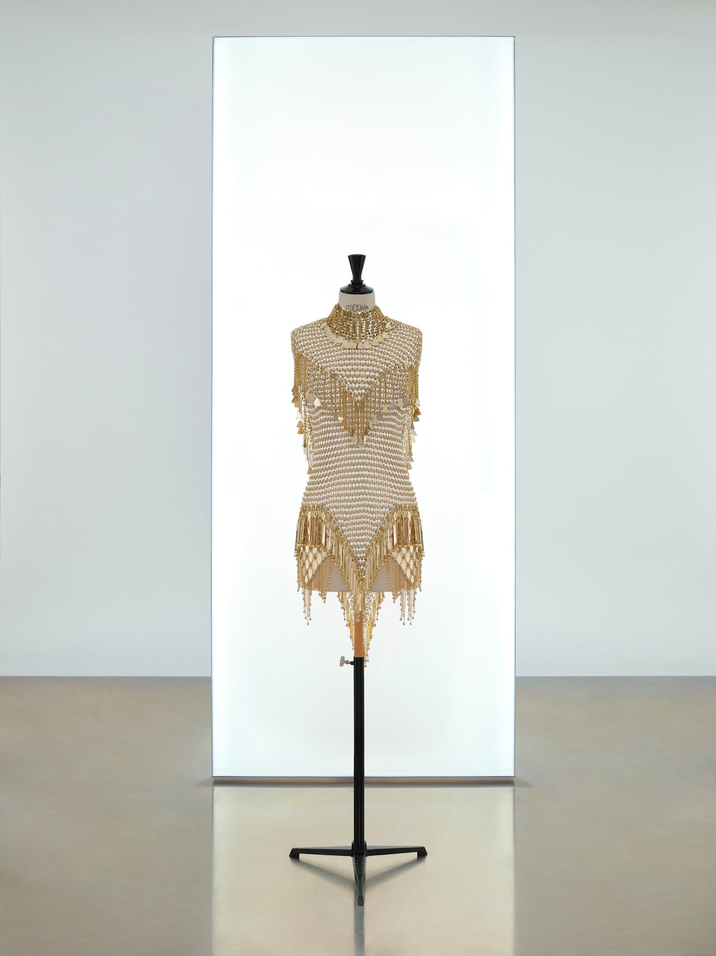 Short dress and mini hooded top made in metallic eight assembly