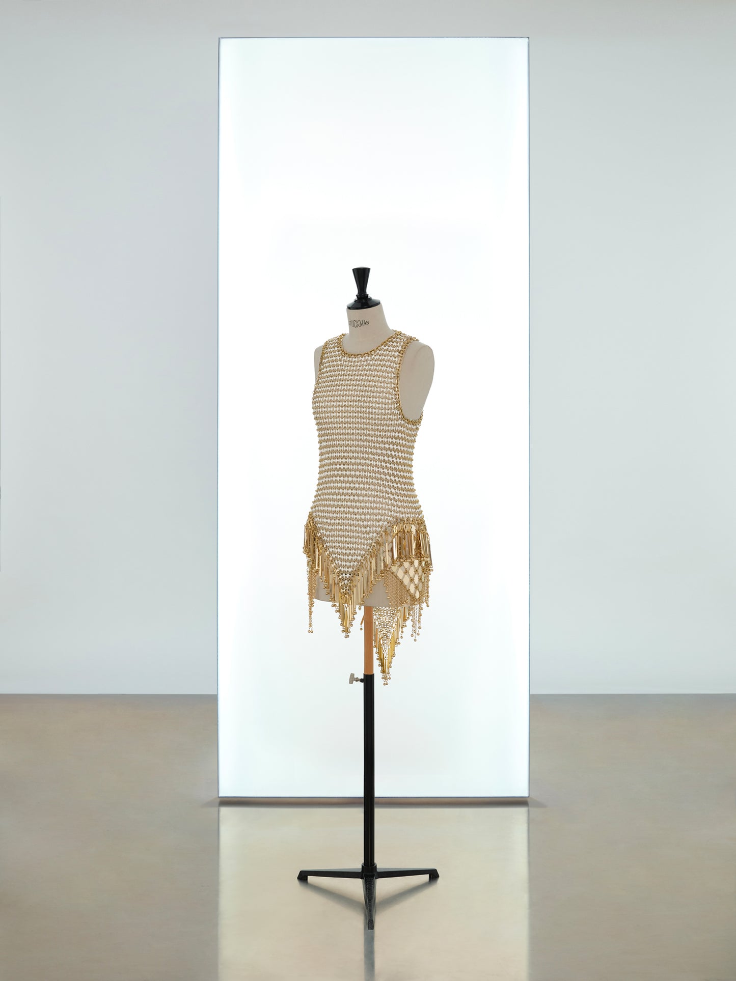 Short dress and mini hooded top made in metallic eight assembly
