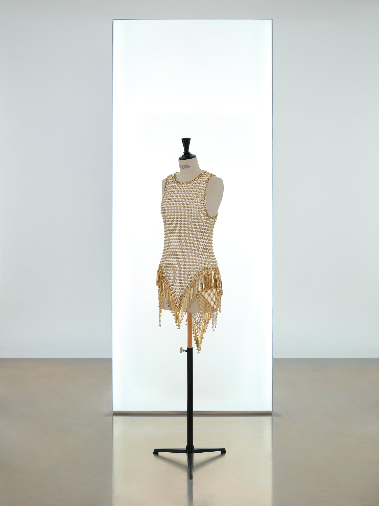 Short dress and mini hooded top made in metallic eight assembly