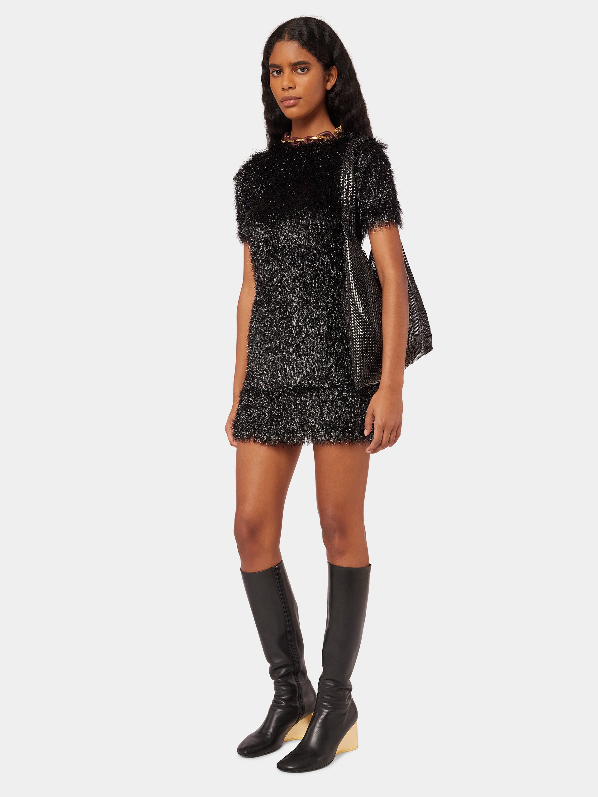 gold dress black boots Brandy in a black & gold asymmetrical cocktail dress & ankle booties